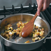 Saut&eacute; eggplant in oil just until cooked but not mushy. The oil will prevent the eggplant from sticking to the pan. 