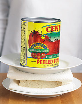 To press tofu, first blot the surface with a towel to remove liquid, then place tofu on a towel-lined plate. Top tofu with another towel and an additional plate. Weigh it down with the heaviest can you have in your pantry. Refrigerate two to 24 hours.