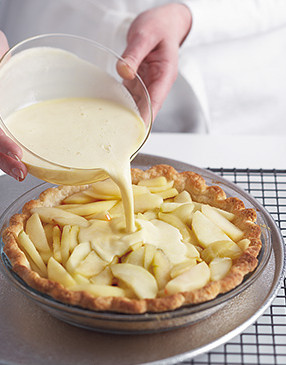 Thoroughly whisk together the egg mixture before pouring it over the apples in the crust.