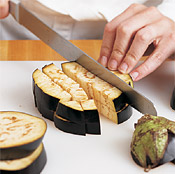 Remove ends from eggplant. Slice the eggplant into rounds, then into cubes. A serrated knife works well.