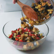 Combine saut&eacute;ed eggplant with fresh vegetables; toss to coat. The eggplant will warm the mixture. 