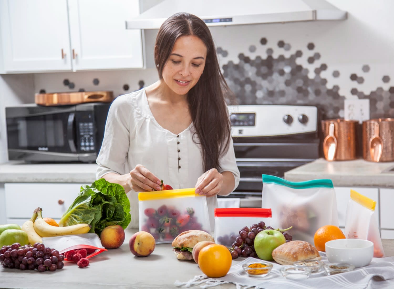 Woman meal-prepping with reusable storage bags